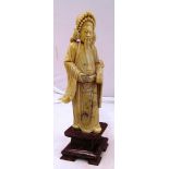 An Oriental soapstone figure on base