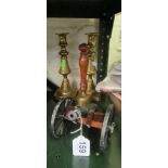A pair of brass candlesticks, brass bell and a cannon