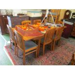 A 1970s teak extending dining table and eight chairs