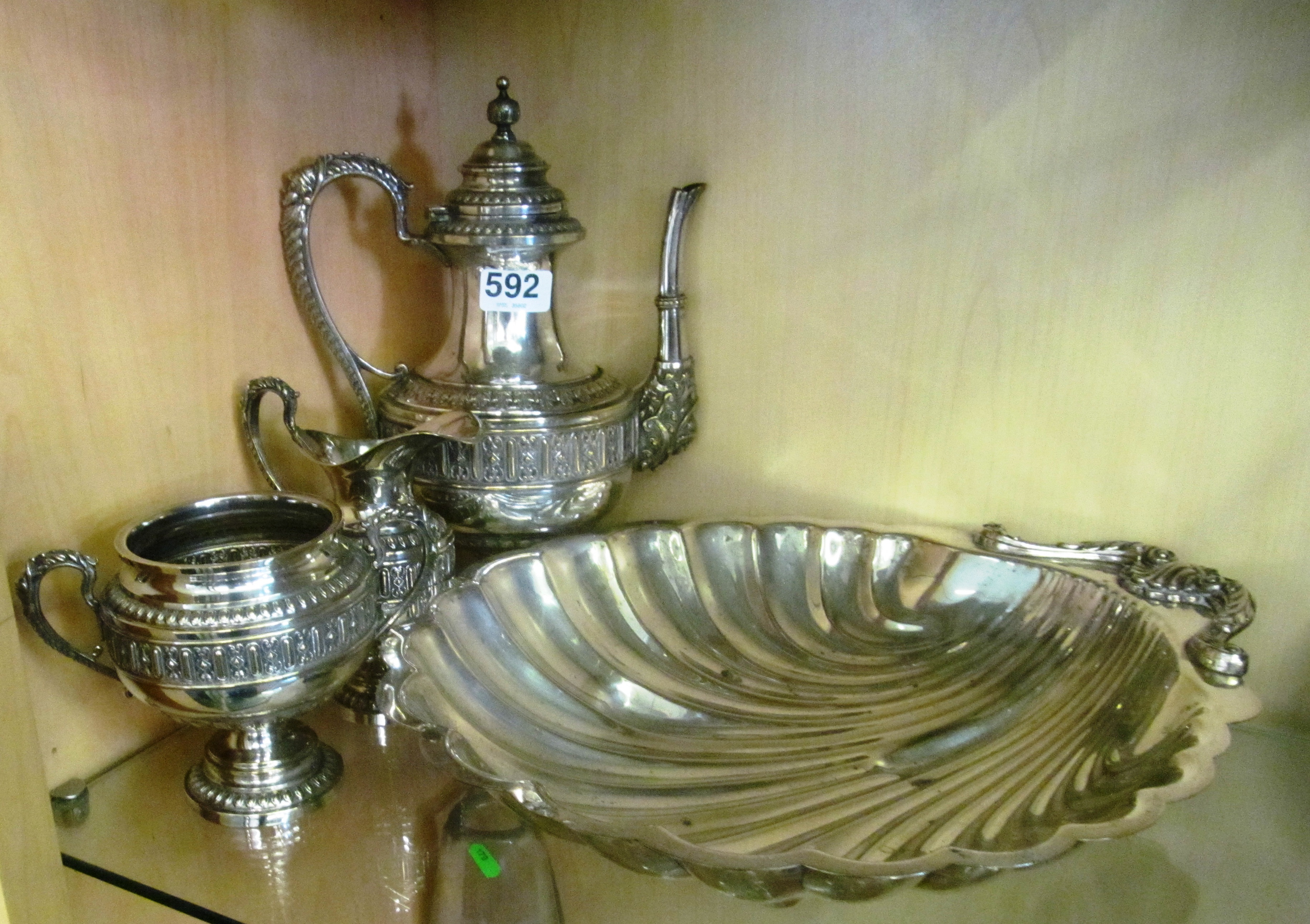 A silver-plated teaset and shell dish