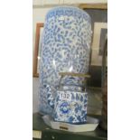 A blue and white stickstand, pot and plate