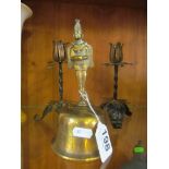 An eastern brass bell and a pair of flower candlesticks