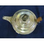 A silver teapot (broken handle)