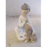 A Lladro boy and dog.