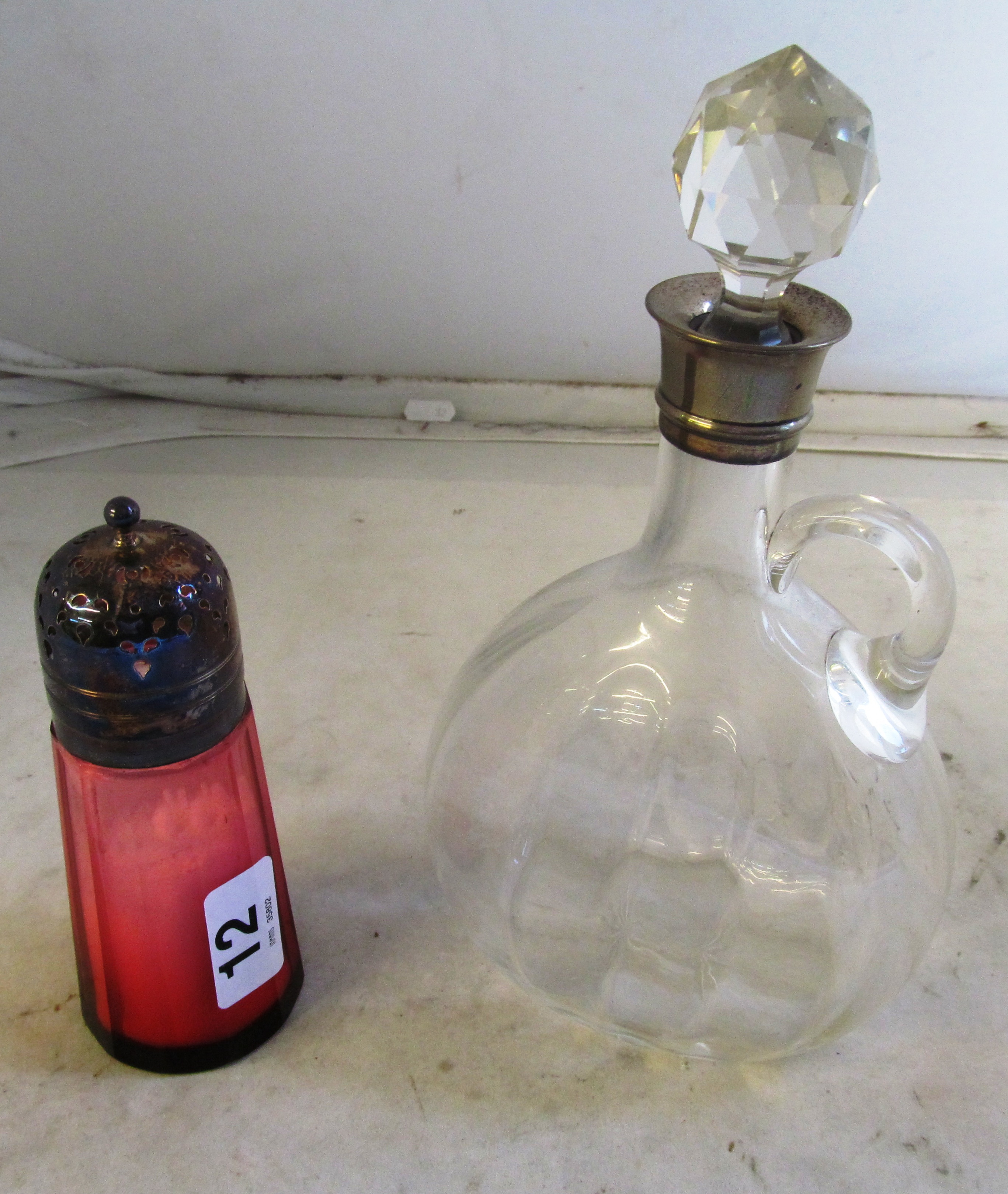 A decanter with silver neck, and Cranberry sifter