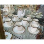 A Noritake gilt and white coffee set, George Jones & Sons coffee cups and saucers, cream and gilt