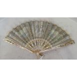 A 19th Century mother of pearl fan the leaf painted with a fete galante scene, a bone fan with