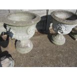 A pair of large stoneware garden urns with lion ring motifs