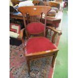 A set of six Edwardian oak chairs:- five standard and carver.