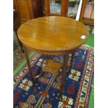 An Edwardian mahogany circular table with lower shelf