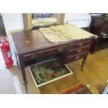 An Edwardian mahogany desk with four drawers on turned supports