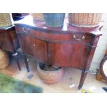 A 19th Century mahogany serpentine fronted cabinet with drawer and two cupboards