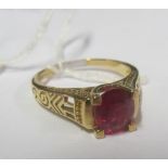 A 9k gold ring set red stone.