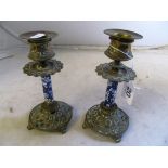 A pair of brass and porcelain candlesticks