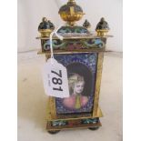 A modern cloisonné clock with portraits to side and enamel dial.