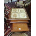 A Teak and tile top nest three tables