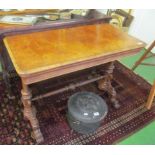 A Victorian walnut card table on twin pillar supports