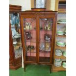 An Edwardian inlaid mahogany two door display cabinet on square legs