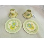 Two Clarice Cliff plates and similar pattern cups and saucers