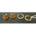 A pair of 9ct gold hoop earrings set white stones and a pair of 14ct gold earrings set orange