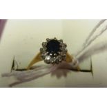 An 18ct gold diamond and sapphire ring