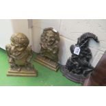 A pair of Punch & Judy doorstops and a metal door stop.