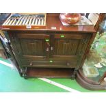 An oak cabinet of two cupboards and drawer.