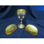 Two brushes and a commemorative cup