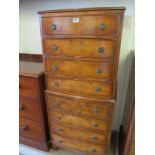 A walnut bow fronted chest on chest of eight drawers