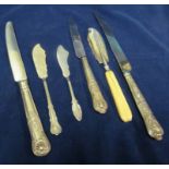 Three silver butter knives and three silver handled knives