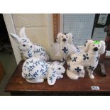 A pair of repro Staffordshire dogs and rabbits.