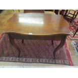 A continental mahogany table on cabriole legs with drawer