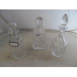 Three decanters one with silver label
