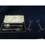 A pair silver knife rests and spoon and fork, boxed