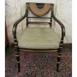 A pair of Regency style black and gilt chairs with demi lune cane back and cane seat and cushion.