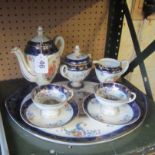 A pretty continental tete a tete teaset decorated reserves of classical figures on tray marked E &