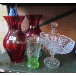 A glass fish, two red vases, and glass.