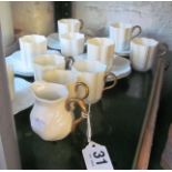 Ten Coalport cream and gilt coffee cups, nine saucers and a cream jug.