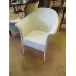 A white Lloyd Loom chair