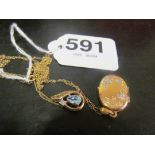 A gold locket on chain and aqua and diamond pendant