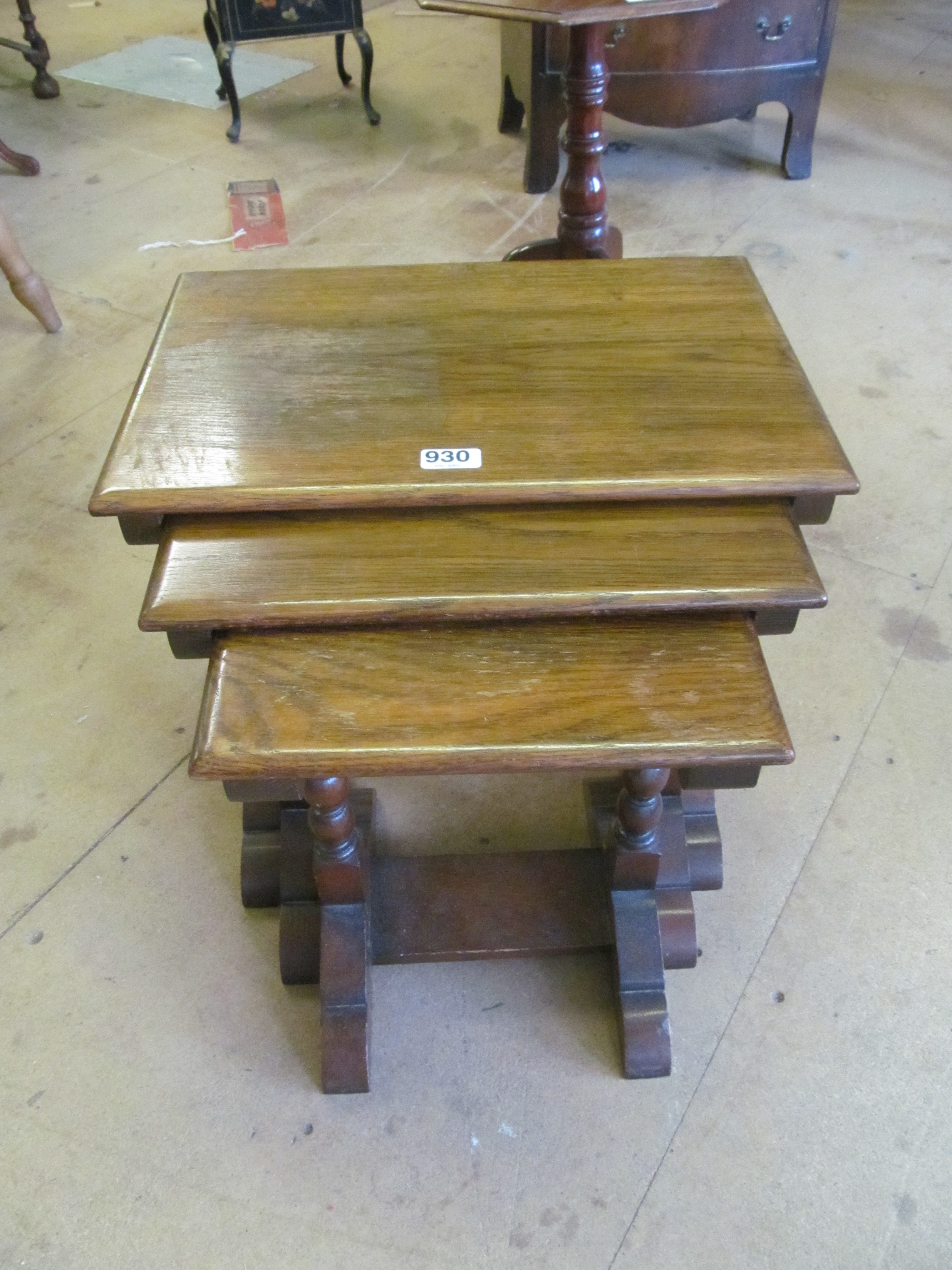 A nest of three oak occasional tables on turned supports