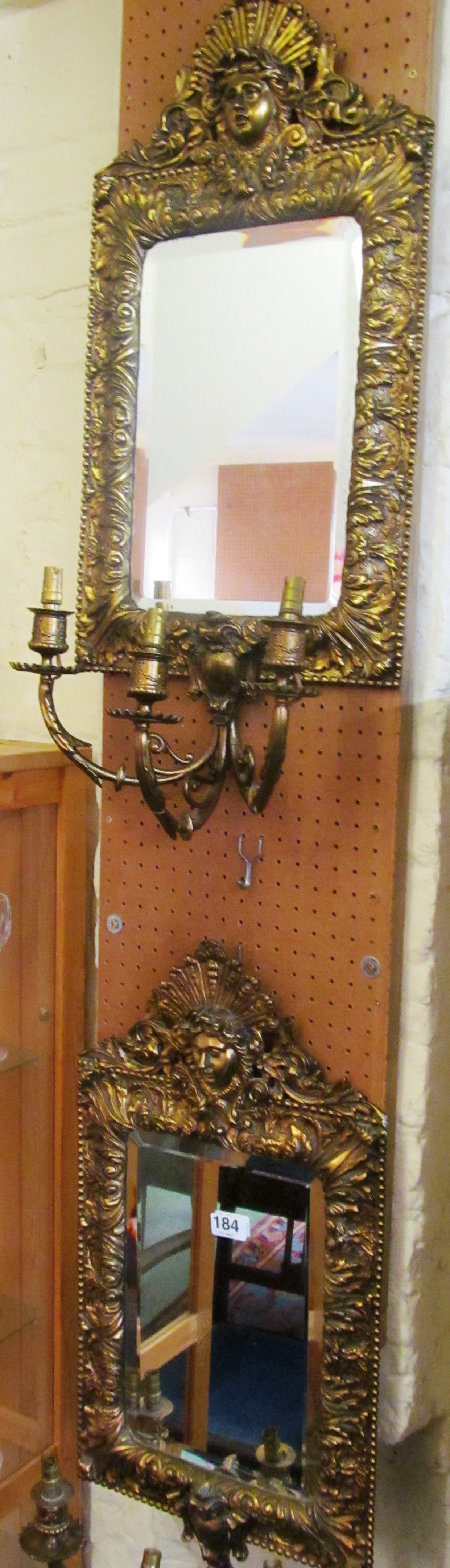 A pair of ornate brass mirrors with female heads to top and embossed leaf frames each with three - Image 2 of 2