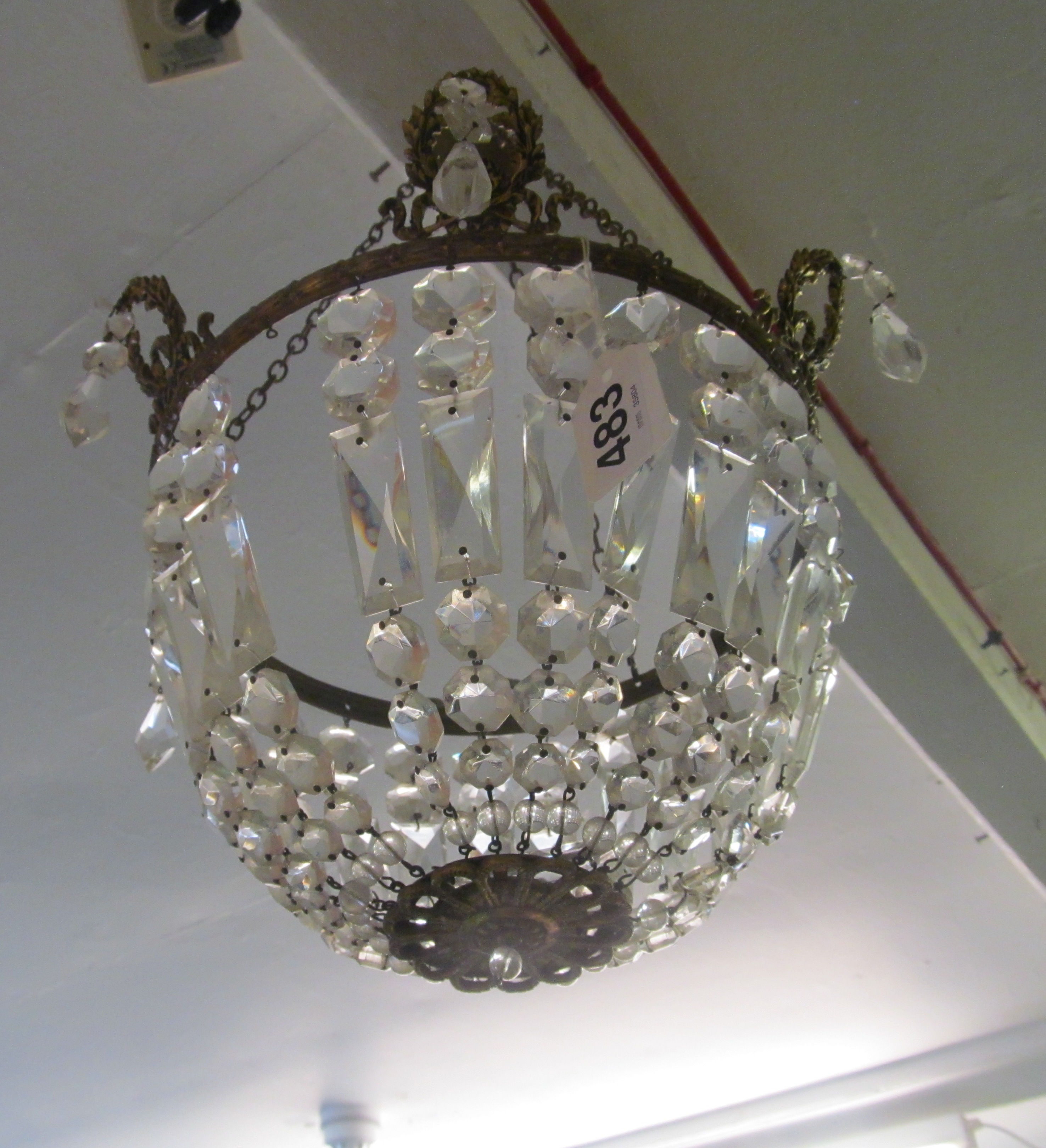 A glass bag chandelier with wreath motif to rim