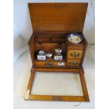 A glass fronted oak writing box with inkwells
