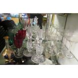 Four Cranberry drinking glasses, other antique glasses and a pair of candlesticks