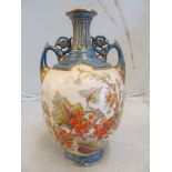 A Worcester vase decorated leaves and berries on cream ground with blue and gilt neck and base