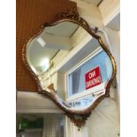A shaped giltwood mirror