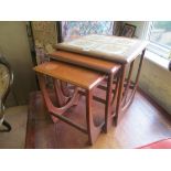 A nest of three teak and tile top tables