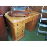 A pine twin pedestal desk with gallery and seven drawers