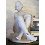 A white sculpture of girl signed